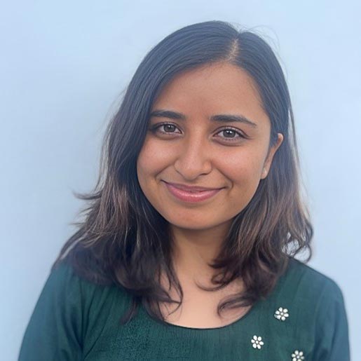 Head shot of a smiling Nepali woman with shoulder length hair