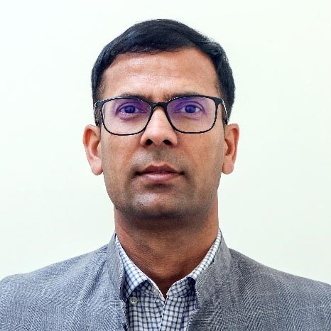 Head shot of a Nepali man wearing glasses