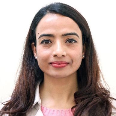 Head shot of a smiling Nepali woman with long dark hair